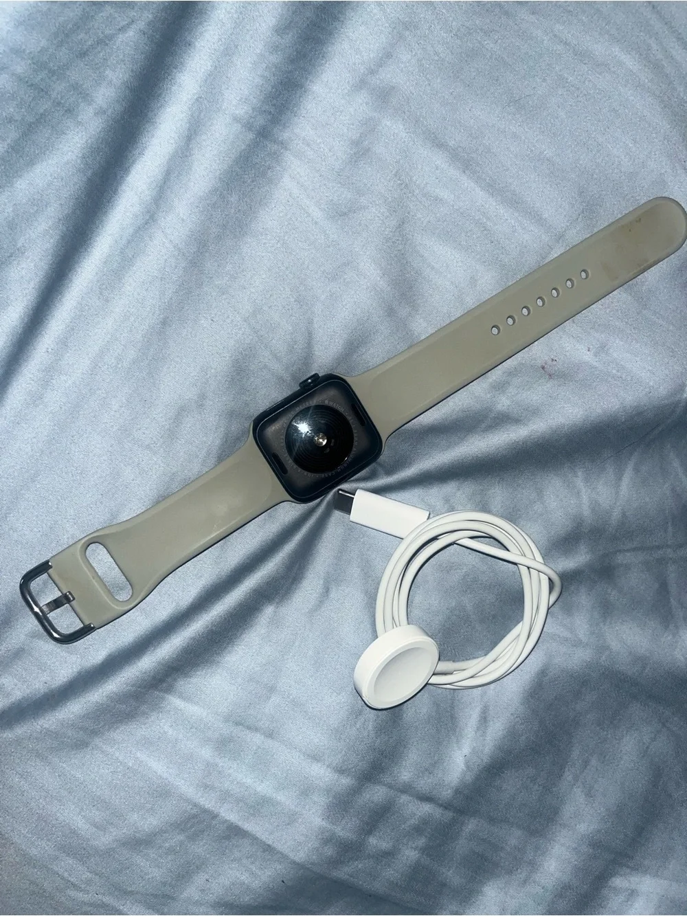 Apple Watch with Beige Sport Band and White Charger